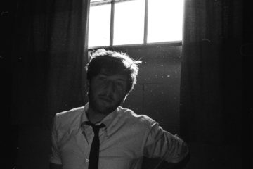 Drew Beskin wearing a white shirt and black tie