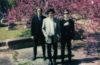 three members of Small Reactions in a cemetery
