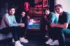 Members of Walden sitting around a television