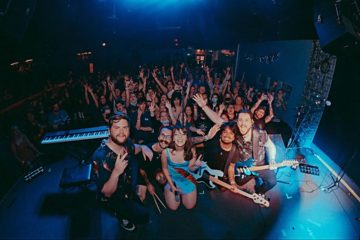 glimmers posing in front of a sold-out crowd in Purgatory at the Masquerade