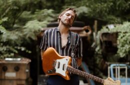 Spencer Thomas holding an electric guitar