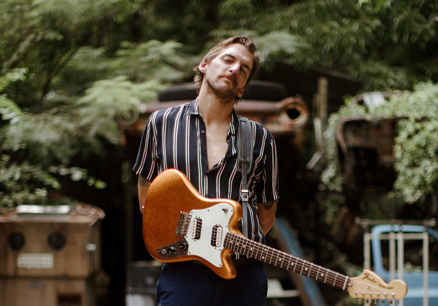 Spencer Thomas holding an electric guitar