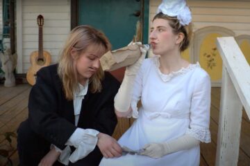 members of Nihilist Cheerleader dressed as bridge and groom drinking from bottle