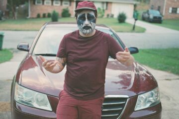 Jake Cook standing in front of a car
