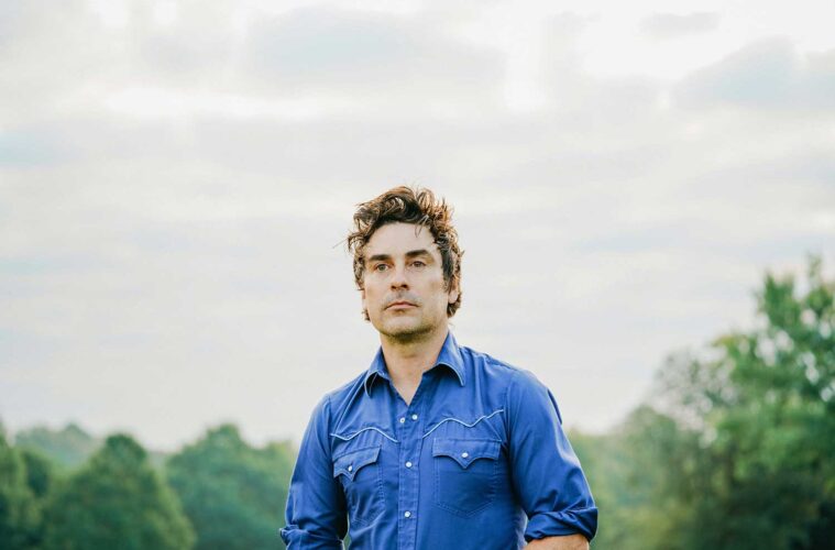 Eliot Bronson wearing a blue shirt