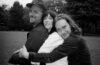 members of Bizner hugging one another
