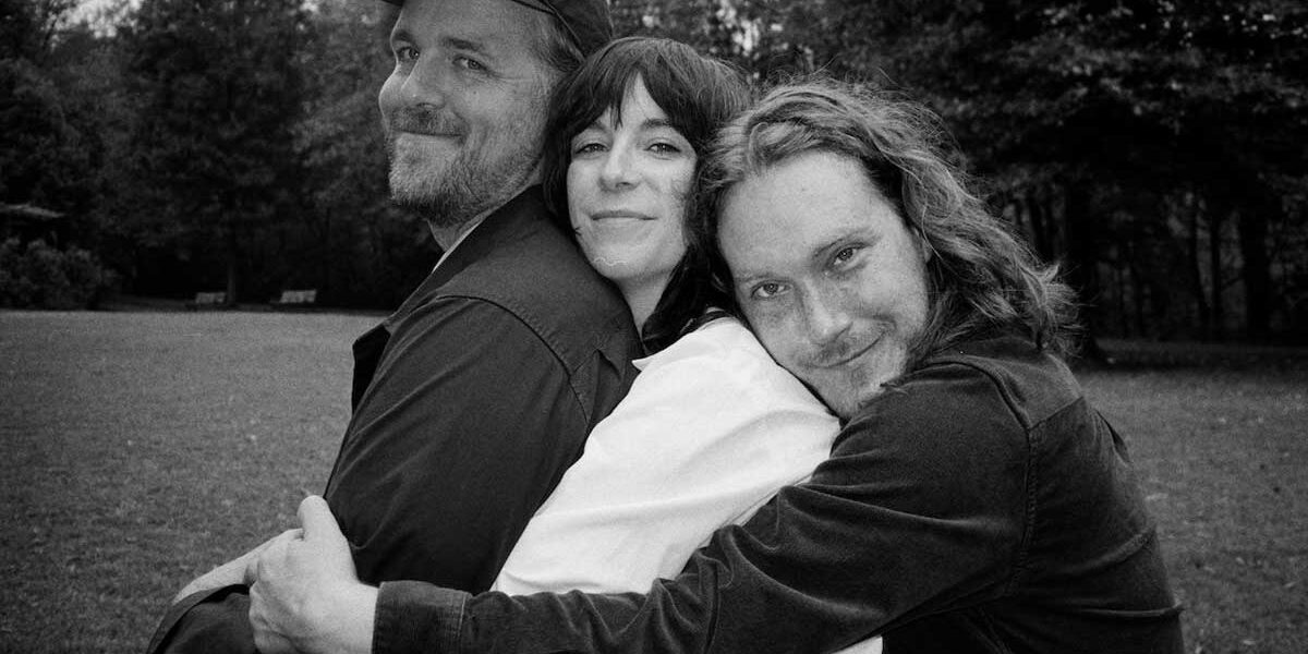 members of Bizner hugging one another