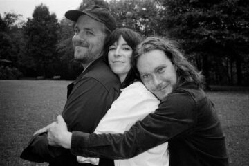 members of Bizner hugging one another